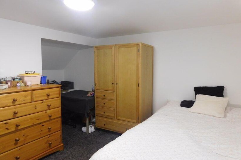 A bright and welcoming master bedroom featuring...