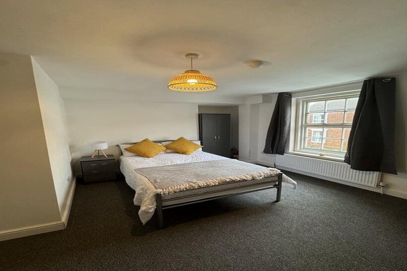 Bright and cozy double bedroom featuring a comf...