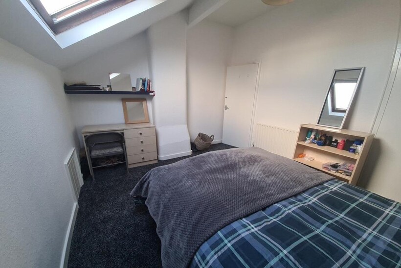 A bright and comfortable master bedroom featuri...