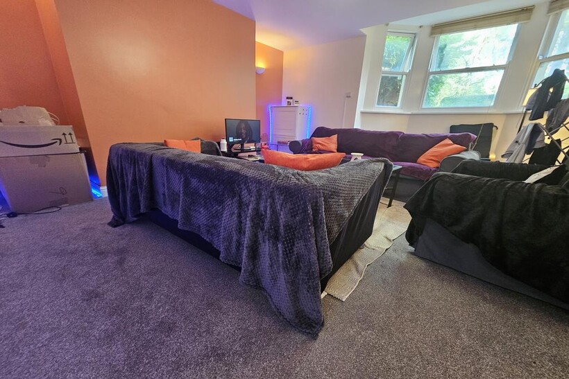 A cozy living room featuring a comfortable seat...