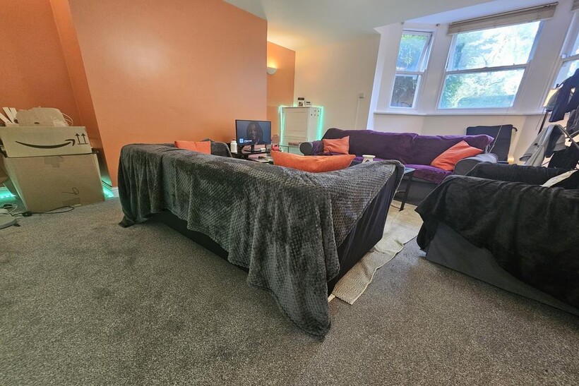 A spacious double bedroom featuring a large bed...