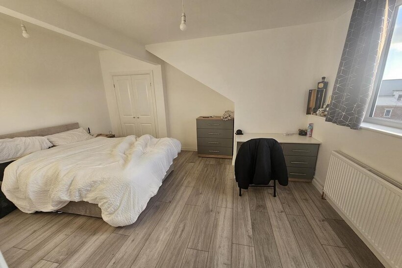 Bright and spacious master bedroom featuring a ...