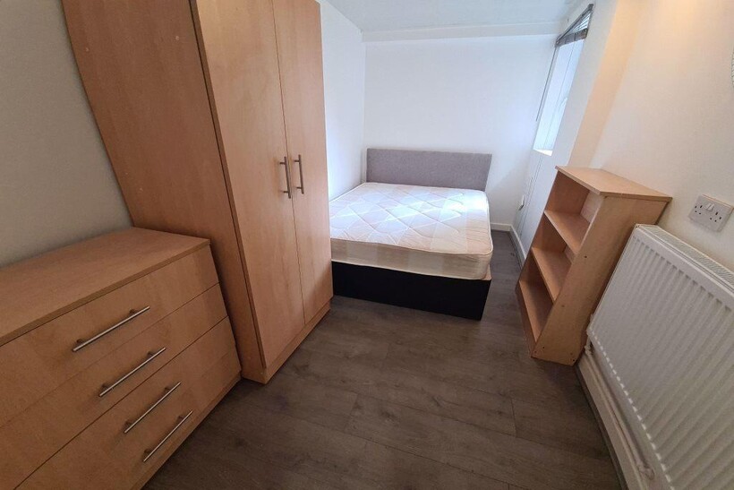 A neat and functional student bedroom featuring...