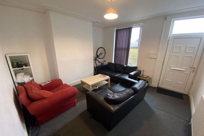 A bright and welcoming living room featuring a ...