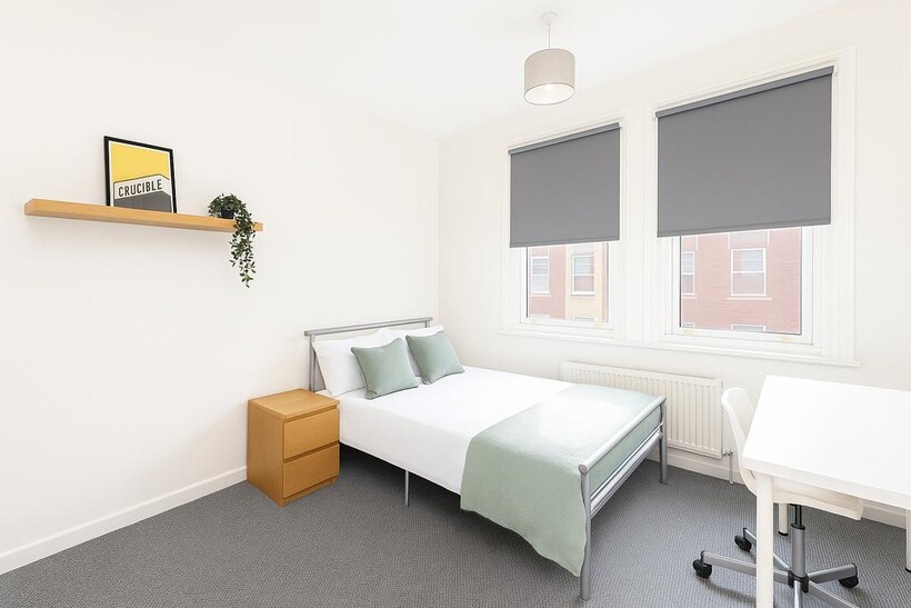 A bright and modern single bedroom featuring a ...