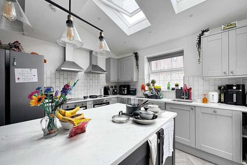 Bright and modern kitchen with ample natural li...