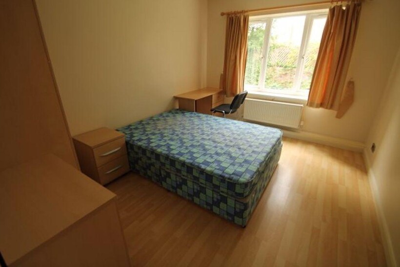 Bright and tidy double bedroom featuring a comf...