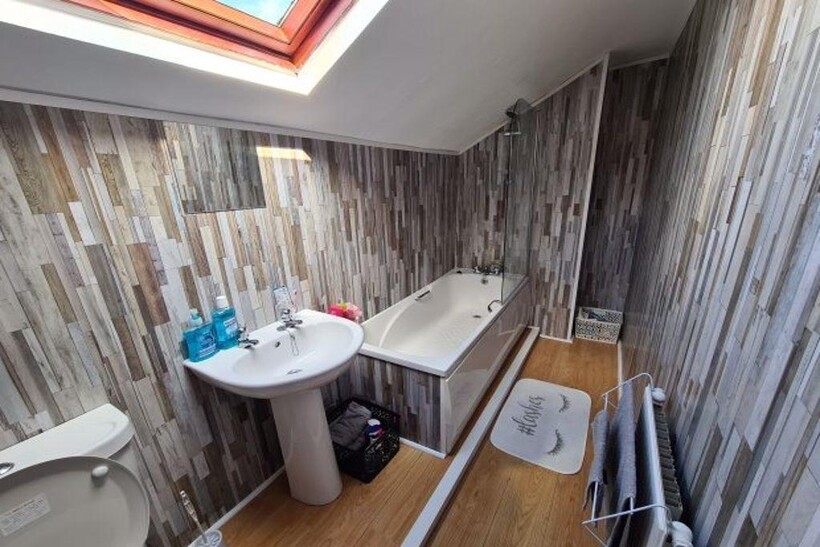 A clean and brightly lit bathroom featuring a b...