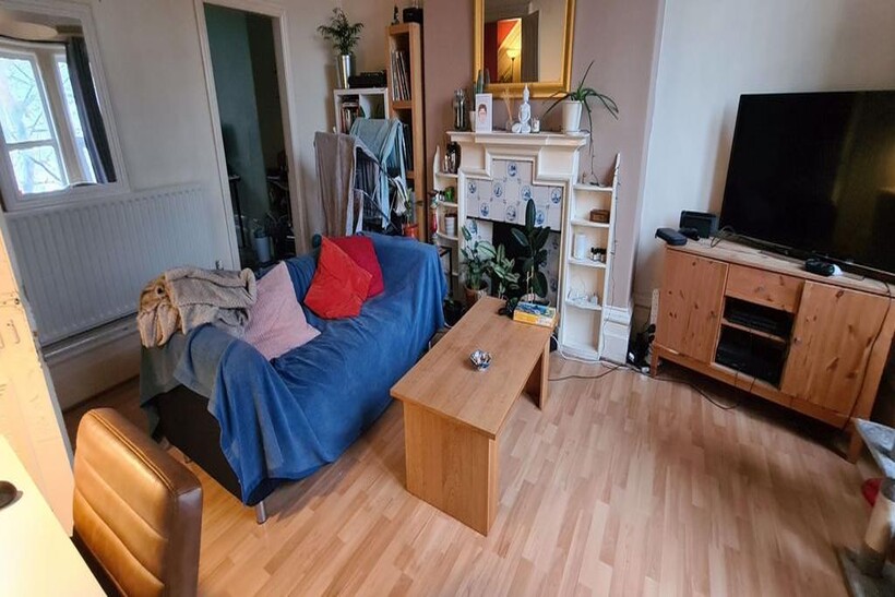 A bright and spacious living room featuring a c...