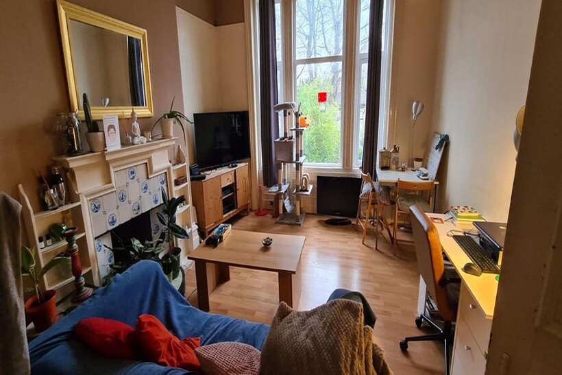 A well-lit, inviting living room featuring comf...