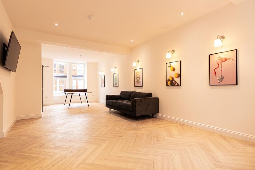 A spacious, well-lit living room featuring a co...