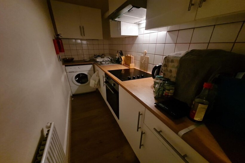 A cozy kitchen space featuring essential applia...