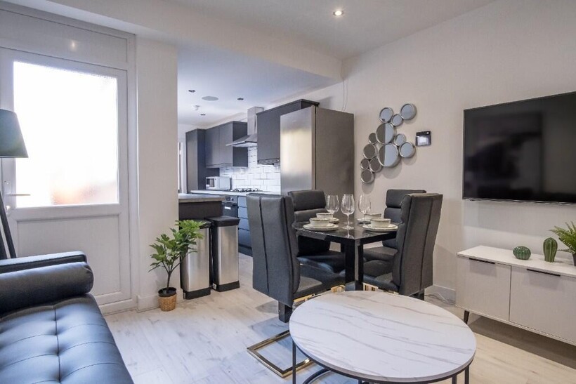 A contemporary and spacious living room with mo...