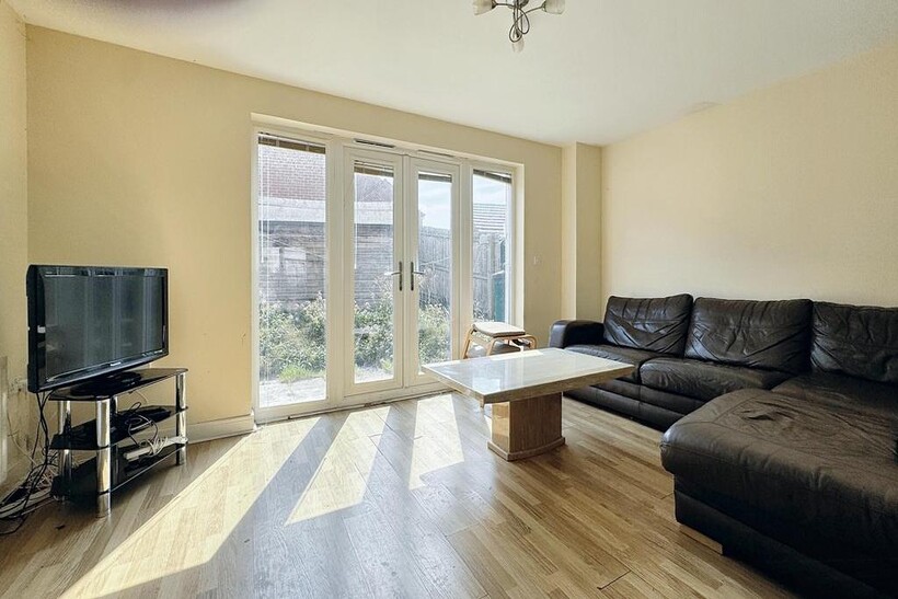 A bright and spacious living room featuring a l...