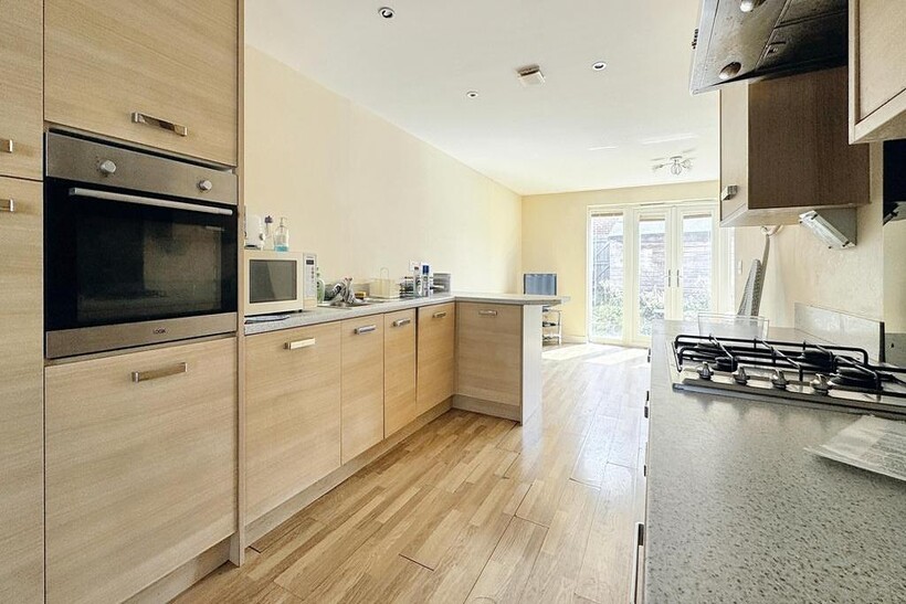 A bright and modern kitchen with ample natural ...