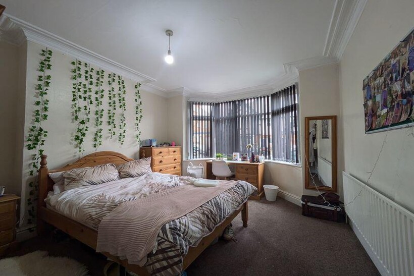 A bright and inviting master bedroom with a spa...