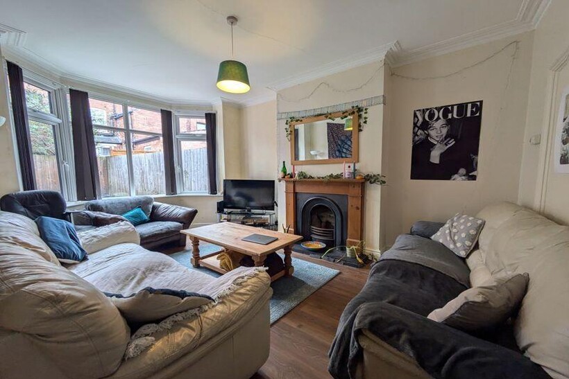 A bright and welcoming living room featuring co...