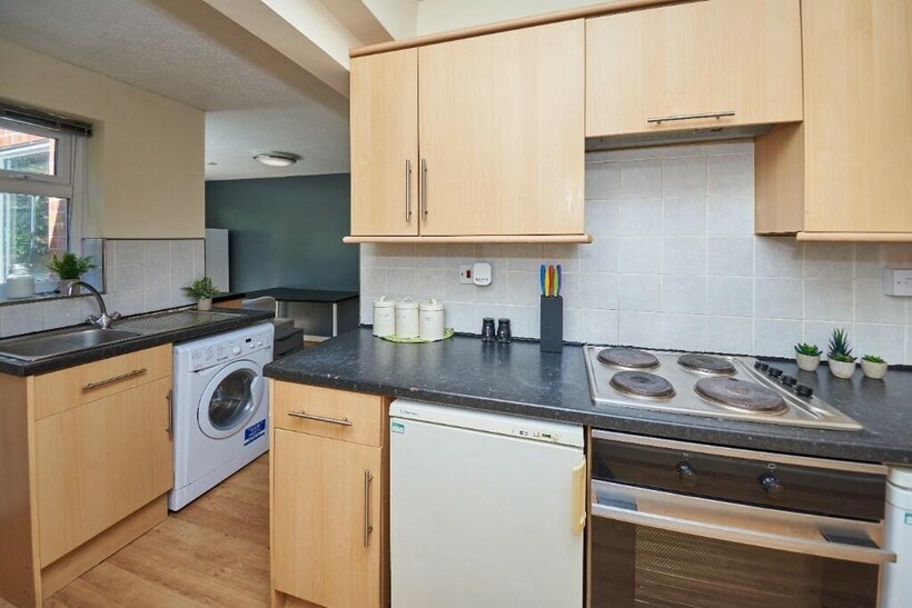A bright and modern kitchen area with well-main...
