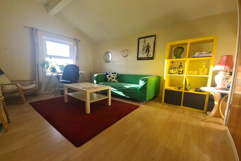 A bright and welcoming living room featuring a ...