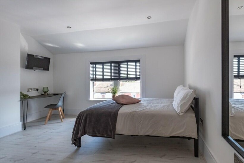 A modern double bedroom featuring a comfortable...