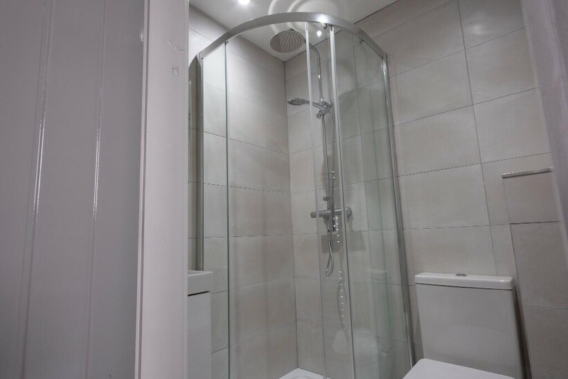 A clean, modern bathroom with a spacious shower...