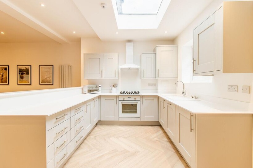 Bright, modern kitchen with generous worktops, ...