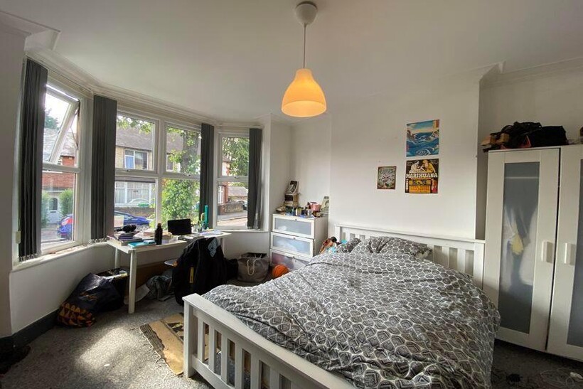 A bright and welcoming double bedroom featuring...