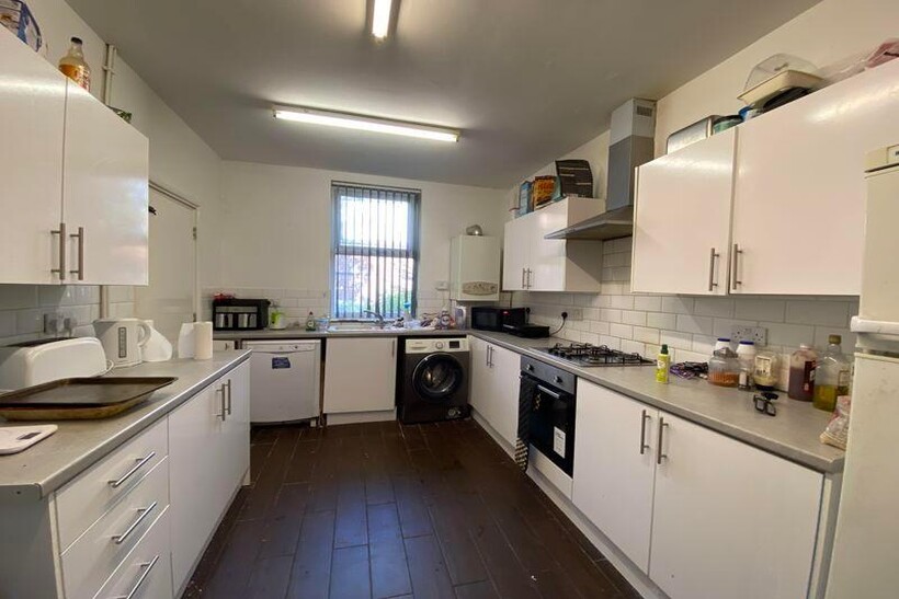 A well-maintained kitchen with ample cabinetry,...