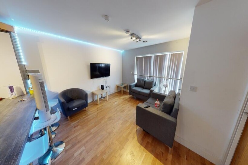 A spacious and well-lit contemporary living roo...