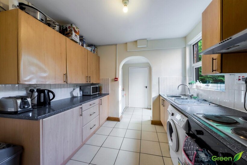 A well-maintained kitchen featuring ample cabin...