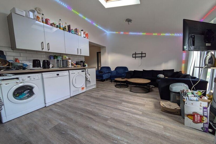 A spacious and well-lit living room with contem...