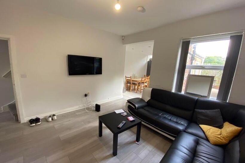 A modern, well-lit living room featuring a blac...