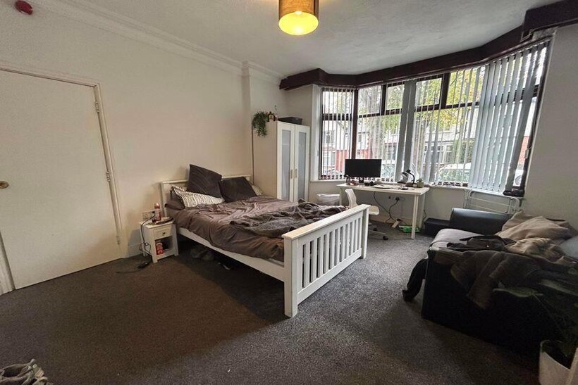 Bright, well-appointed bedroom with a comfortab...