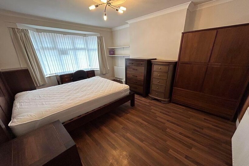 A well-maintained bedroom featuring a double be...