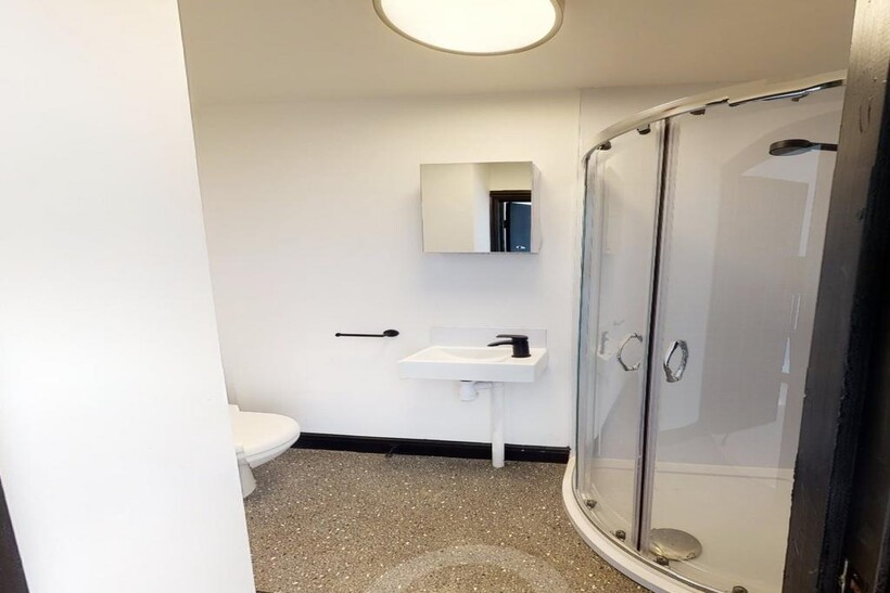 Modern student bathroom with a shower cubicle, ...