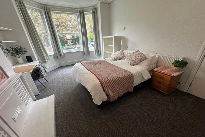 Bright and welcoming living room with large bay...