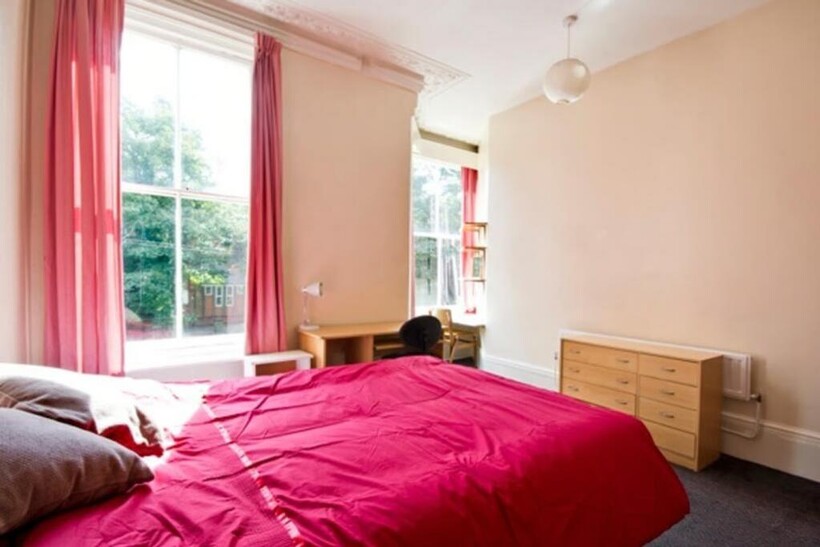 A bright and spacious double bedroom featuring ...