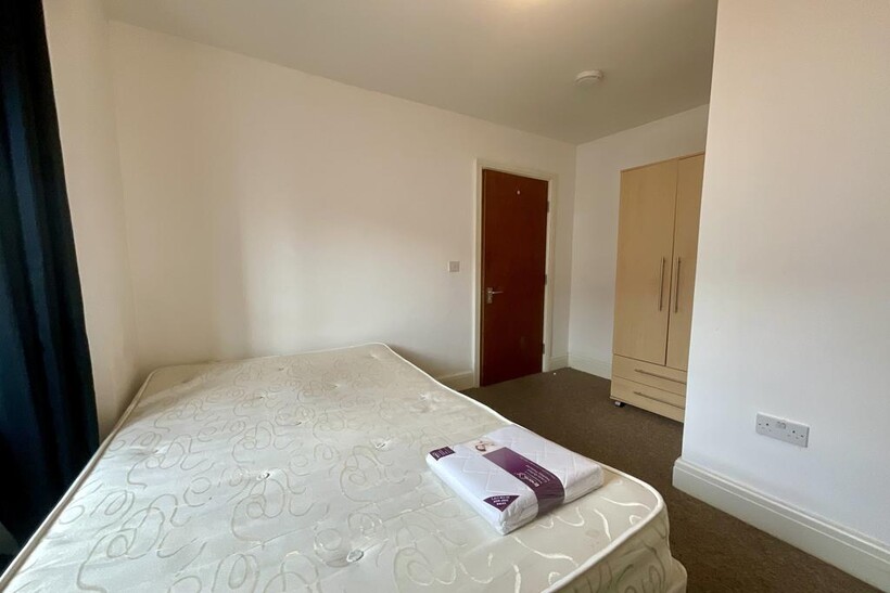 A bright and spacious master bedroom featuring ...