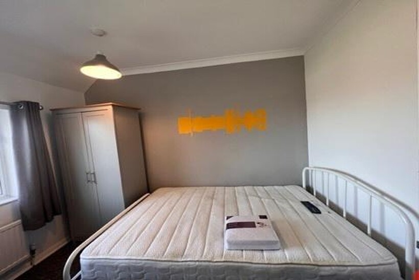 A bright and spacious master bedroom with a com...