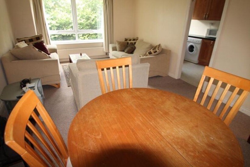 A bright and inviting living room featuring com...