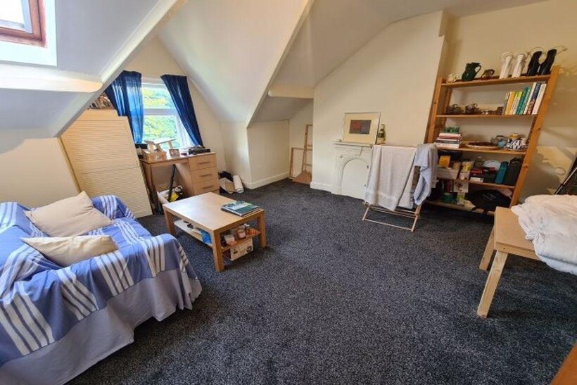 A spacious and cozy master bedroom featuring a ...