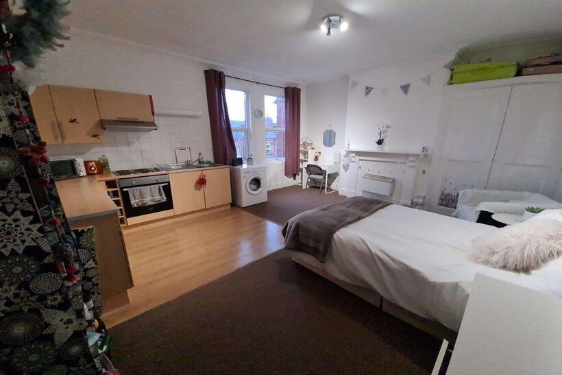 Bright and spacious bedroom featuring a comfort...