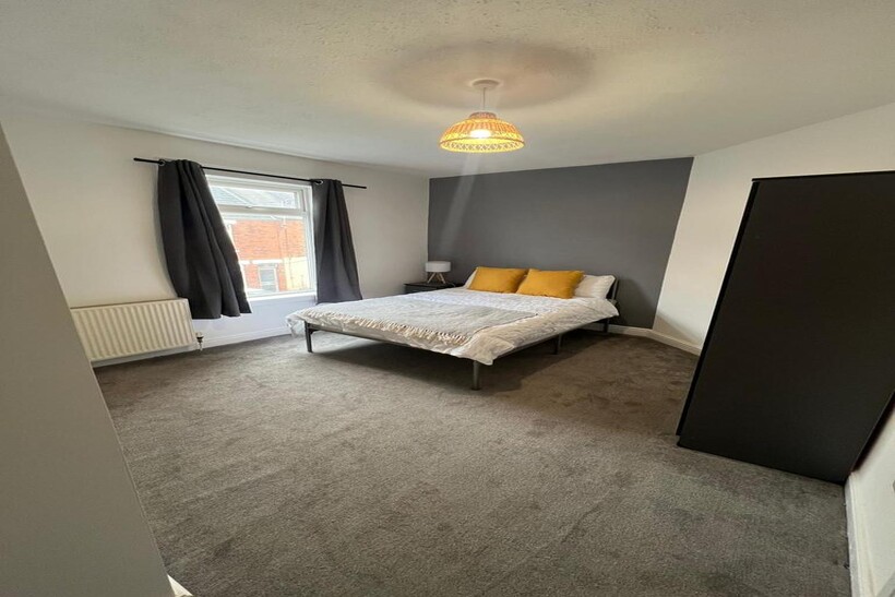 Bright and tidy double bedroom featuring a comf...