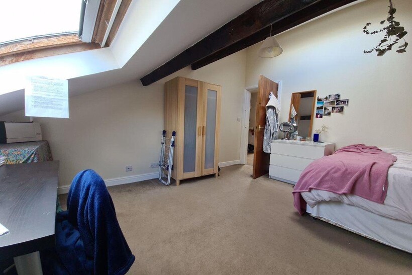 Bright double bedroom with a sloped skylight, e...