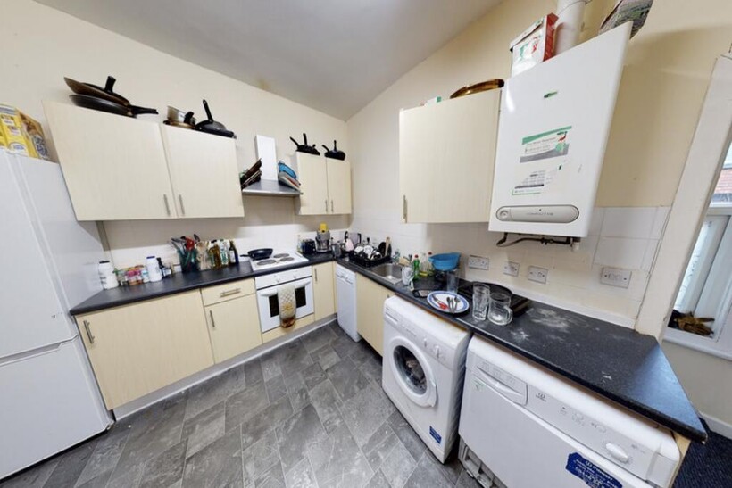 Modern and well-lit kitchen with ample counter ...