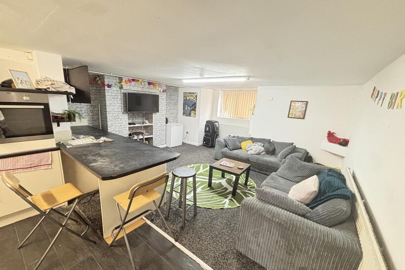 A spacious and modern living room featuring com...