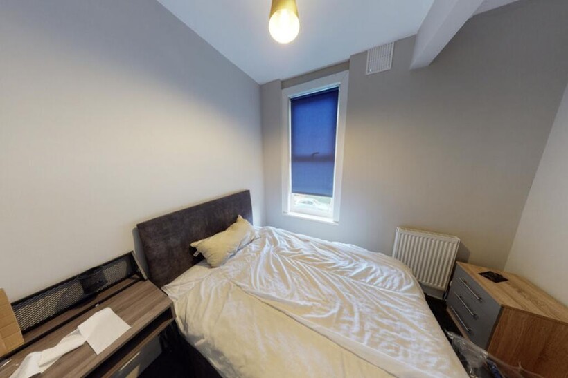 A bright, well-maintained bedroom featuring a c...