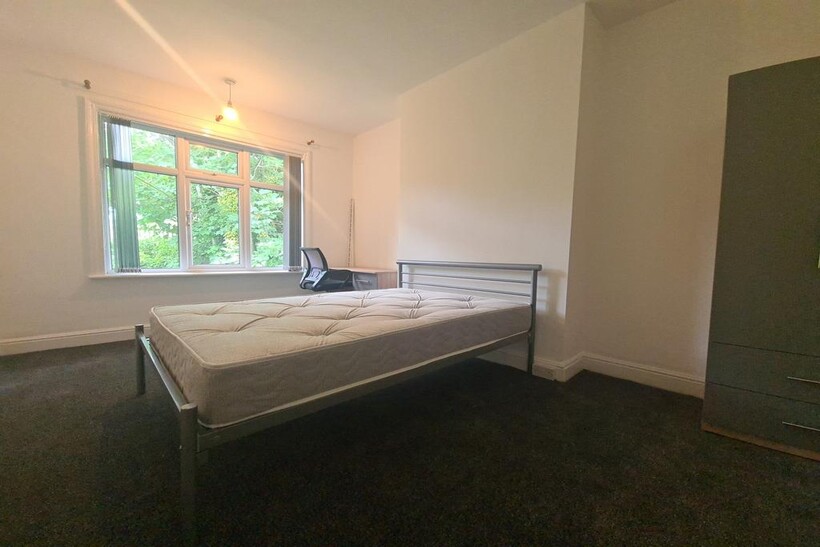 A bright and cozy single bedroom with a comfort...