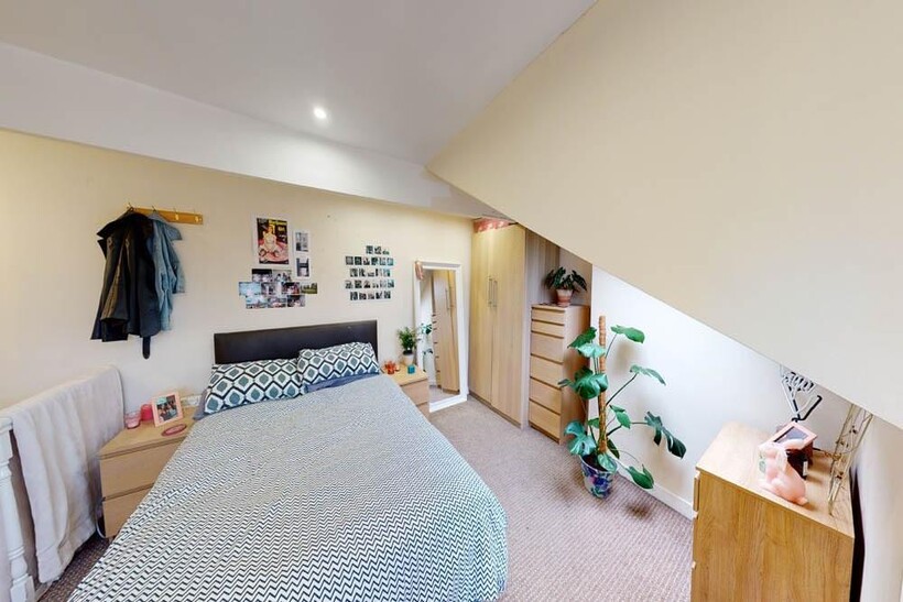 A bright and well-maintained bedroom featuring ...