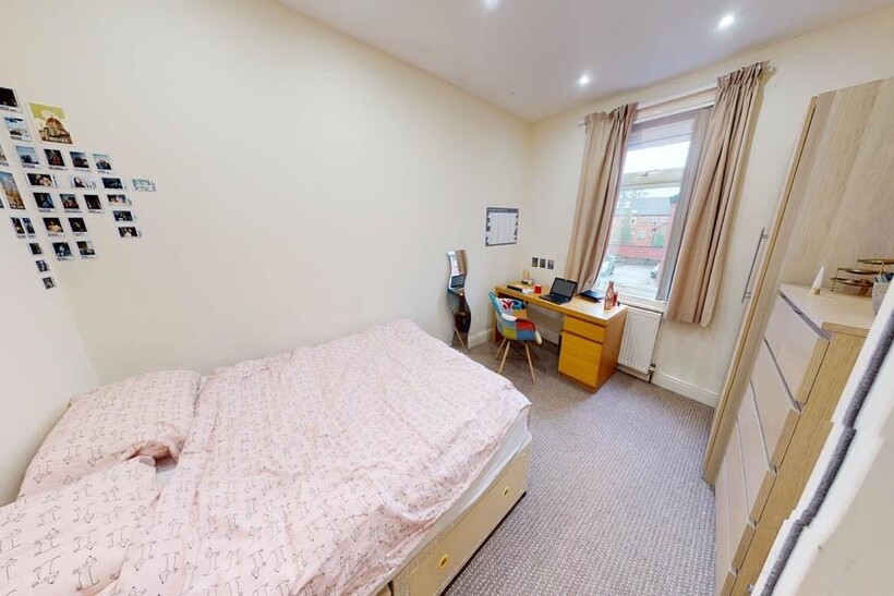 Bright and welcoming double bedroom featuring a...